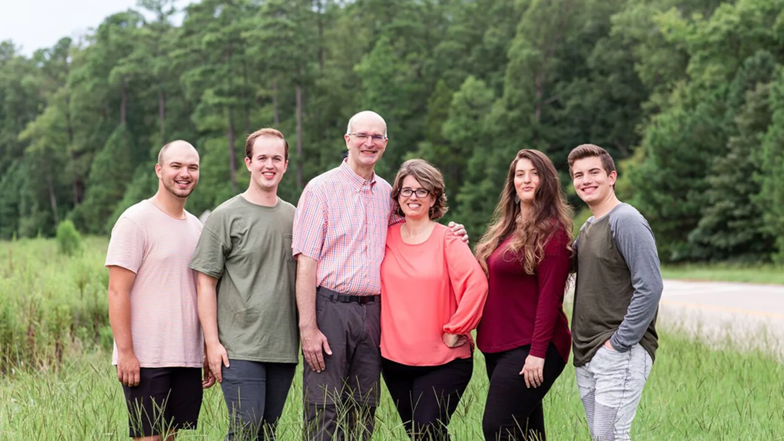 The Rasmussen family standing together outdoors